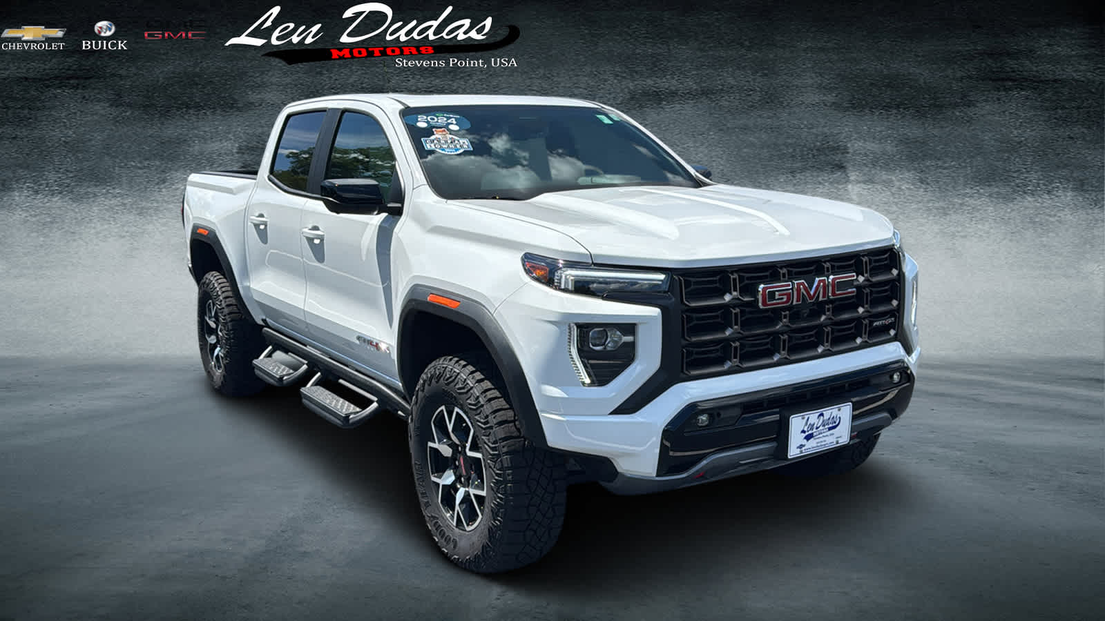 2024 GMC Canyon AT4X in Summit White — front three-quarter view